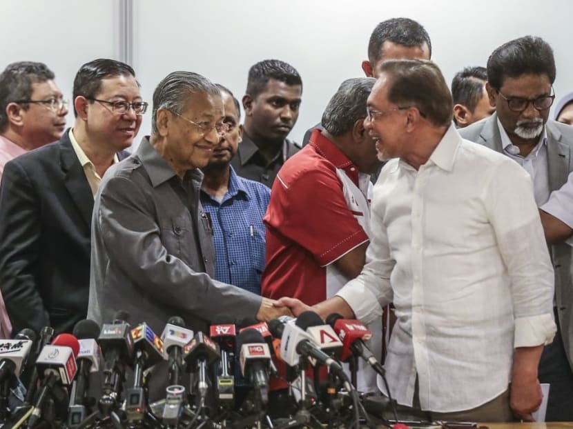 Dr Mahathir Mohamad (left) shakes hands with Mr Anwar Ibrahim during a press conference in Kuala Lumpur on Jan 4, 2019.