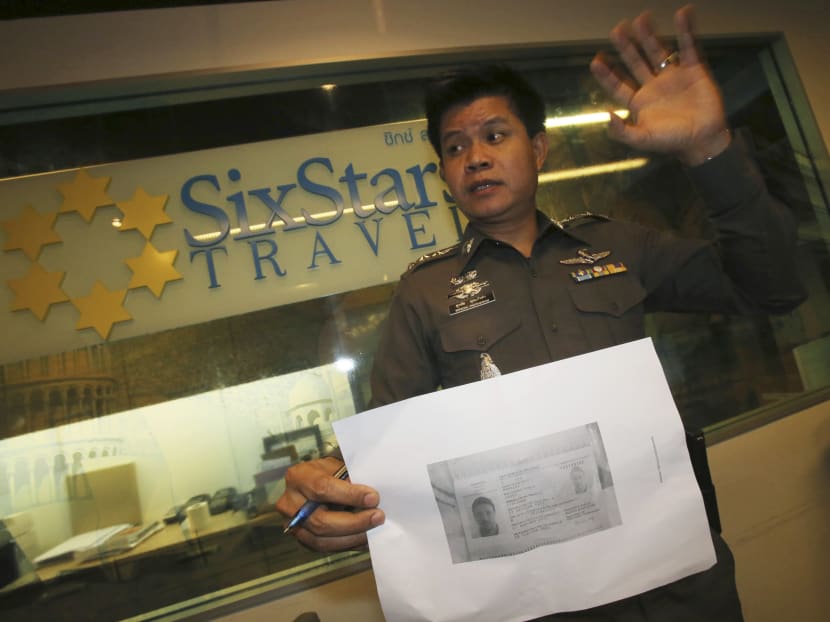 A Thai police officer showing a copy of Luigi Maraldi’s stolen passport to the media in Pattaya, Chonburi province Thailand on Monday ,March 10, 2014. Photo: AP