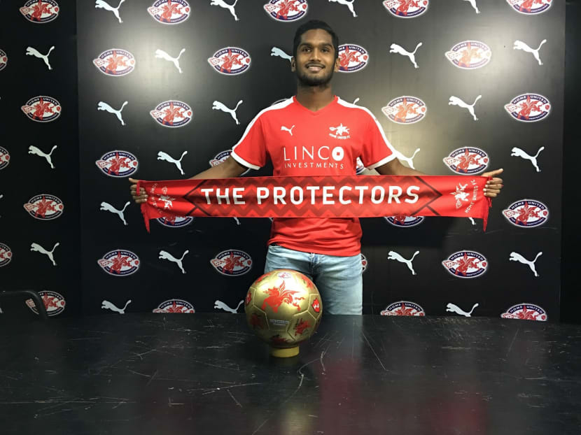 Hariss Harun holding a Home United scarf during his unveiling by the S.League club in March. According to his parent club Johor Darul Ta'zim, he will continue to stay with the Protectors until a suitable overseas offer comes along. TODAY FILE PHOTO