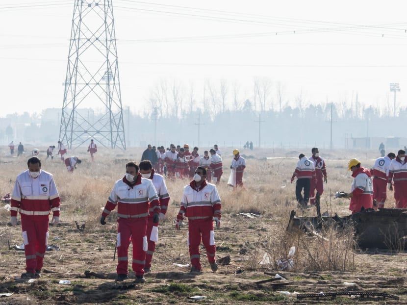 Rescue workers at the site of the plane crash near Tehran on Wednesday.