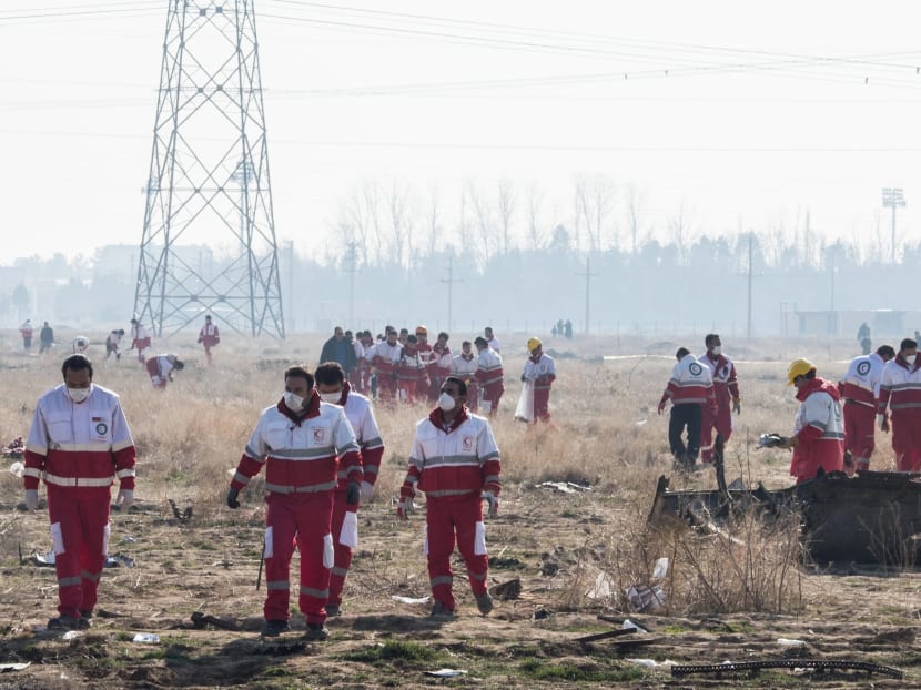 Rescue workers at the site of the plane crash near Tehran on Wednesday. Rescue workers at the site of the plane crash near Tehran on Wednesday.