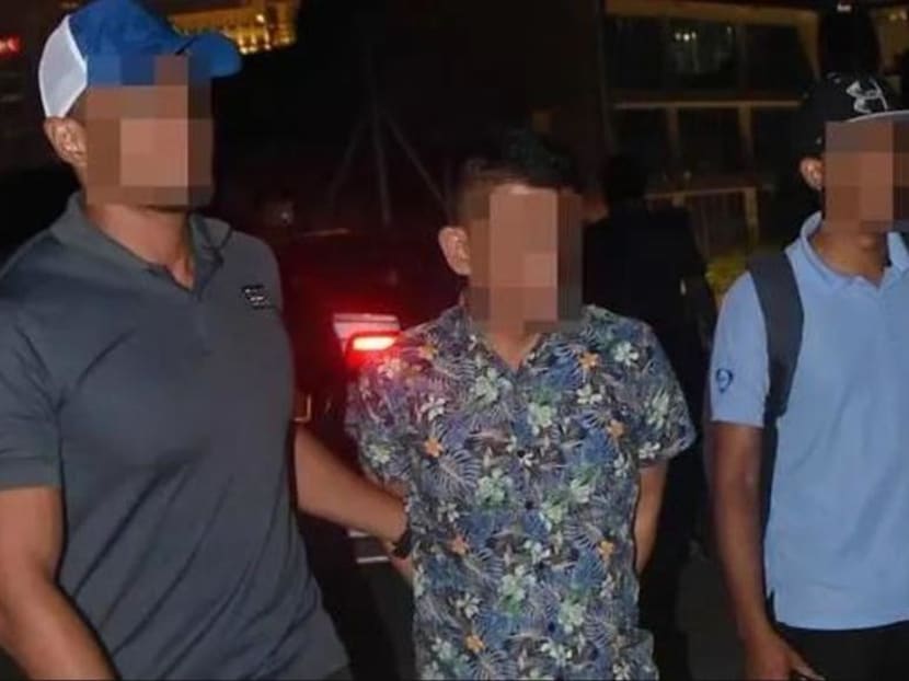 Mohamed Kazali Salleh (centre), a Singaporean, was arrested by Malaysian Special Branch officers in December 2018.