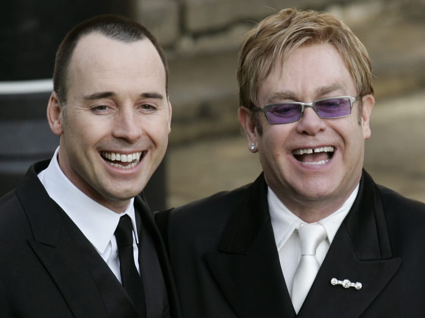 In this 2005 file photo, British musician Elton John , right, and his longtime partner David Furnish, smile to the media and the public after their civil ceremony, at the Guildhall in the town of Windsor, England. Photo: AP