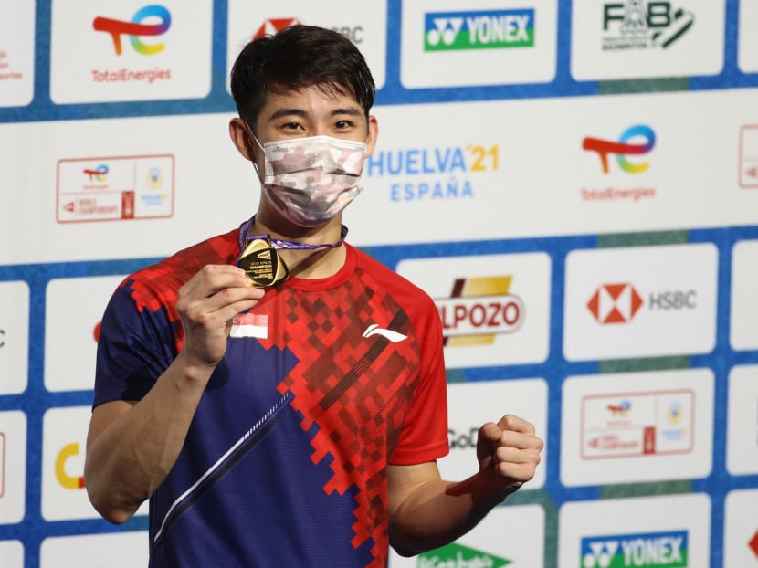 Singapore's Loh Kean Yew celebrates on the podium after winning the men's singles final badminton match of the BWF World Championships in Huelva, on Dec 19, 2021.