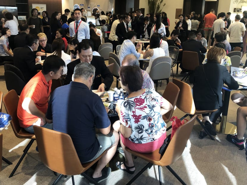 Mr Alex Poh, chairman of Pearl Bank Apartments’ collective sales committee, guiding his former neighbours (in the foreground) in their potential purchases at the new One Pearl Bank condominium sales gallery's opening day on July 13, 2019. Photo: Wong Pei Ting Mr Alex Poh, chairman of Pearl Bank Apartments’ collective sales committee, guiding his former neighbours (in the foreground) in their potential purchases at the new One Pearl Bank condominium sales gallery's opening day on July 13, 2019. Photo: Wong Pei Ting