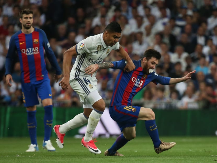Real Madrid's Casemiro (in white) and Barcelona star Lionel Messi in action during last season's El Clasico at the Bernabeu on April 23. Photo: Reuters