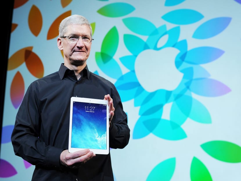 Mr Cook with the iPad Air in October last year. Apple has not unveiled a new iPad since then and consumers have been buying smartphones with bigger screens. PHOTO: BLOOMBERG