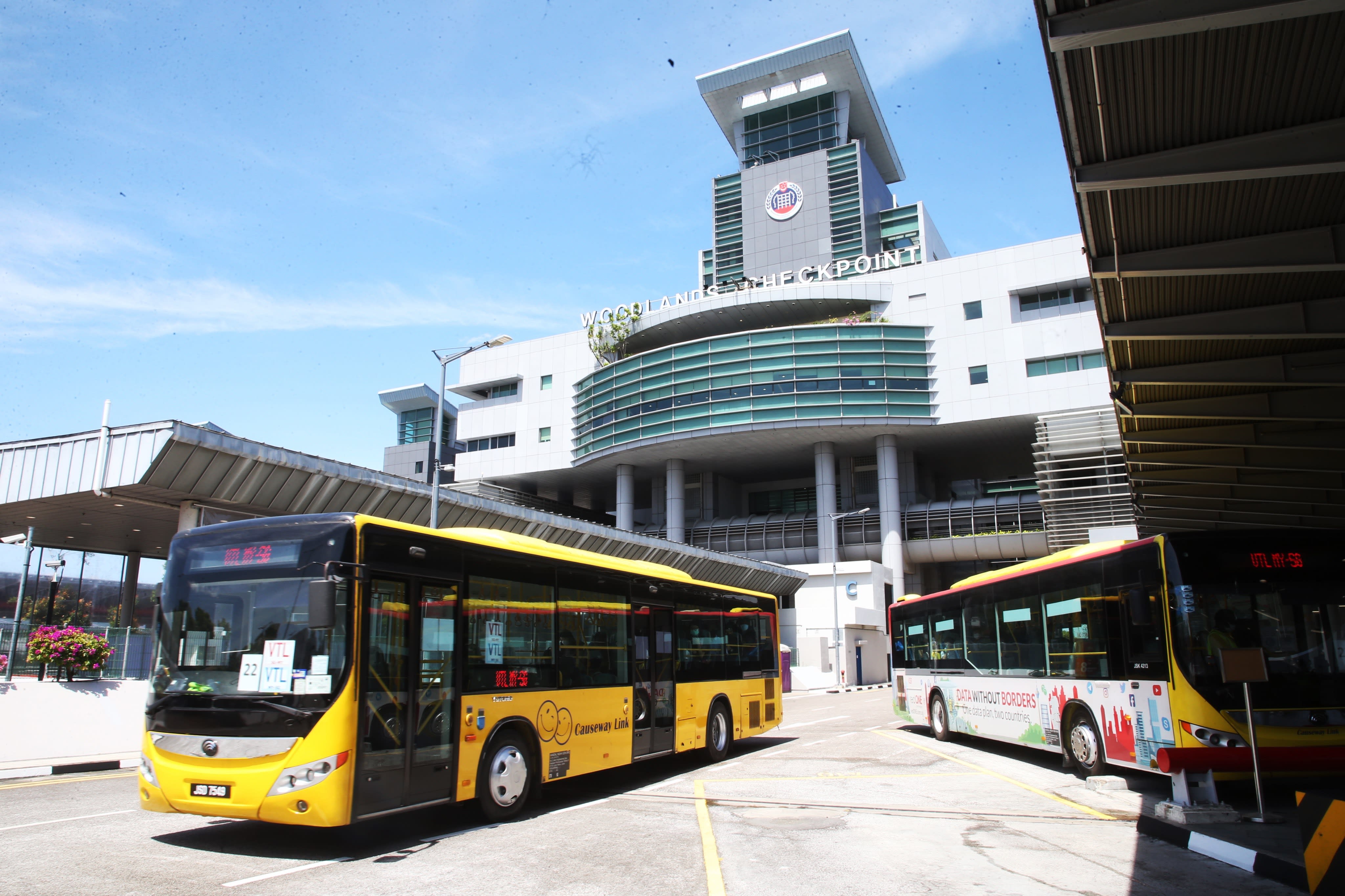 A bus operated by Causeway Link travel agency under the vaccinated travel lane scheme, leaving Woodlands Checkpoint in Singapore.