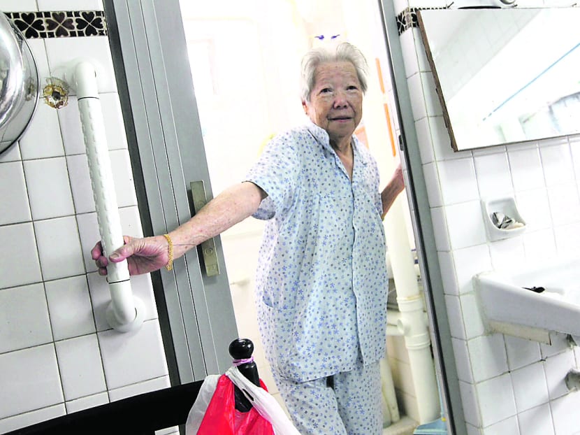 Mdm Loo Wai Heng, 90, using handbar grips installed by HDB to safely navigate through her flat in Marine Drive. TODAY file photo.
