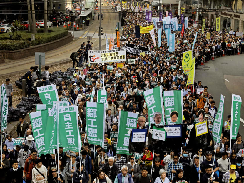 Thousands of protesters marching at a downtown street in Hong Kong on New Year’s Day to protest against Beijing’s interpretation of the Basic Law and the Hong Kong government’s bid to ban pro-democracy lawmakers from taking office. Photo: AP