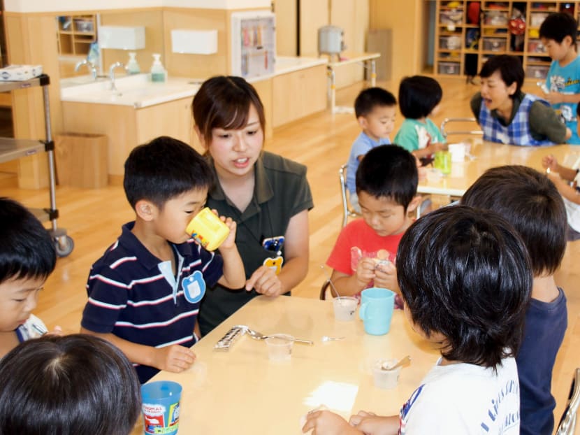 File photo taken in July 2016 shows children during their daycare snack time in Funabashi, Chiba Prefecture. Source: Kyodo