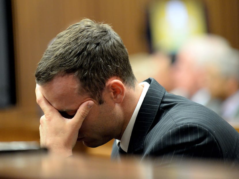 Oscar Pistorius buries his head in his hand as he listens to cross questioning, in the second week of his trial, about the events surrounding the shooting death of his girlfriend Reeva Steenkamp, in court during his trial in Pretoria, South Africa, Monday, March 10, 2014. Photo: AP
