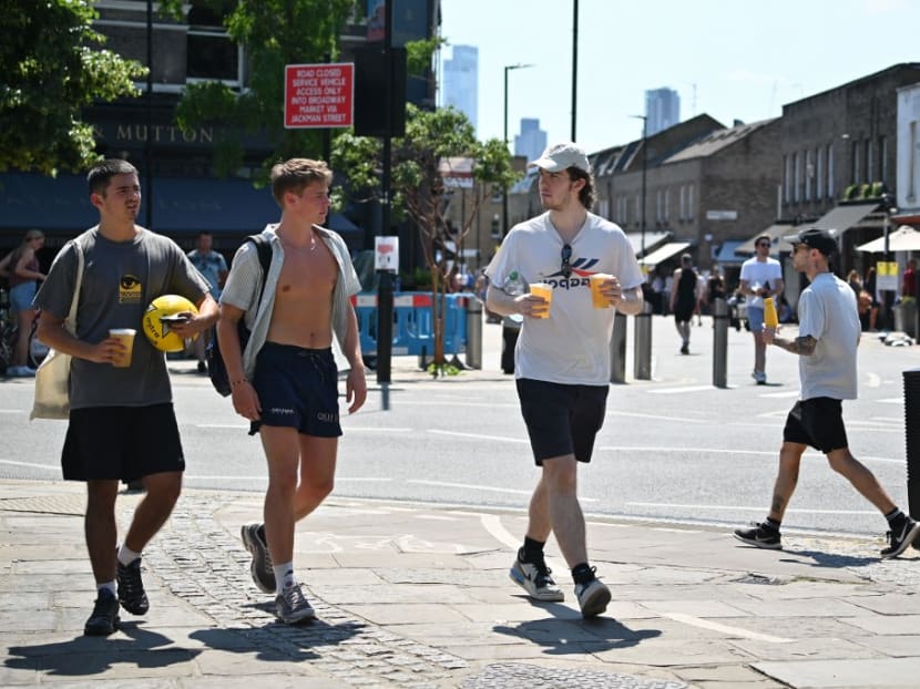 People carry take away drinks as they enjoy the hot weather in Broadway market in east London on June 25, 2020. People carry take away drinks as they enjoy the hot weather in Broadway market in east London on June 25, 2020.