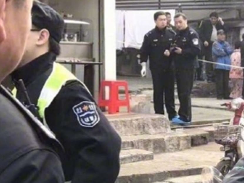 Police attend the noodle store in Wuhan where the owner was beheaded by a customer. Photo: Handout via South China Morning Post