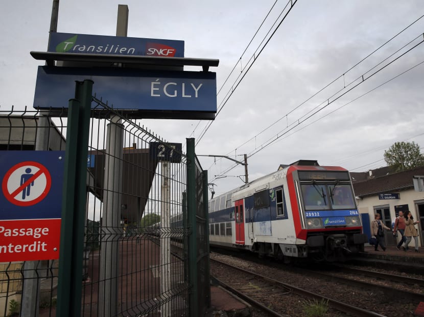 Passengers get off a train at the Egly station, south of Paris, Wednesday, May 11, 2016. French authorities opened an investigation Wednesday after a teenage woman allegedly live-streamed video of her suicide on the popular app Periscope. Photo: AP