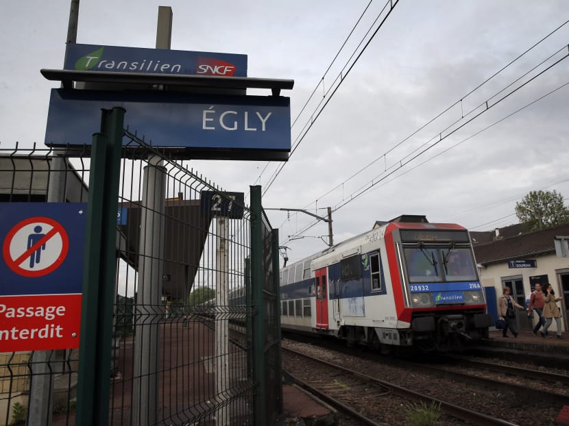 Passengers get off a train at the Egly station, south of Paris, Wednesday, May 11, 2016. French authorities opened an investigation Wednesday after a teenage woman allegedly live-streamed video of her suicide on the popular app Periscope. Photo: AP Passengers get off a train at the Egly station, south of Paris, Wednesday, May 11, 2016. French authorities opened an investigation Wednesday after a teenage woman allegedly live-streamed video of her suicide on the popular app Periscope. Photo: AP