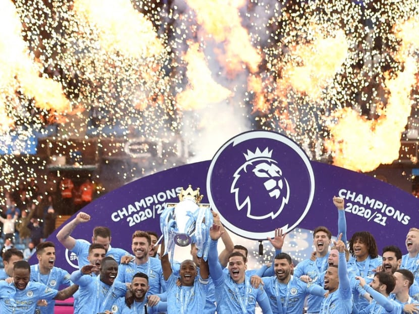 Manchester City's Brazilian midfielder Fernandinho lifts the Premier League trophy during the award ceremony after the English Premier League football match between Manchester City and Everton at the Etihad Stadium in Manchester, north west England, on May 23, 2021.