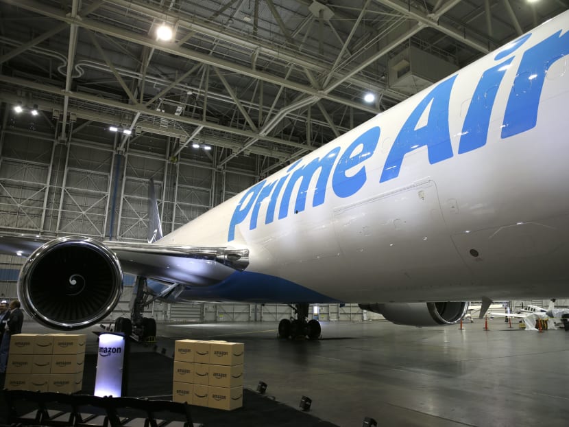 Amazon.com boxes are shown stacked near a Boeing 767, an Amazon "Prime Air" cargo plane on display Thursday, Aug. 4, 2016, in a Boeing hangar in Seattle. Amazon unveiled its first branded cargo plane Thursday, one of 40 jetliners that will make up Amazon's own air transportation network of 40 Boeing jets leased from Atlas Air Worldwide Holdings and Air Transport Services Group Inc., which will operate the air cargo network. Photo: AP