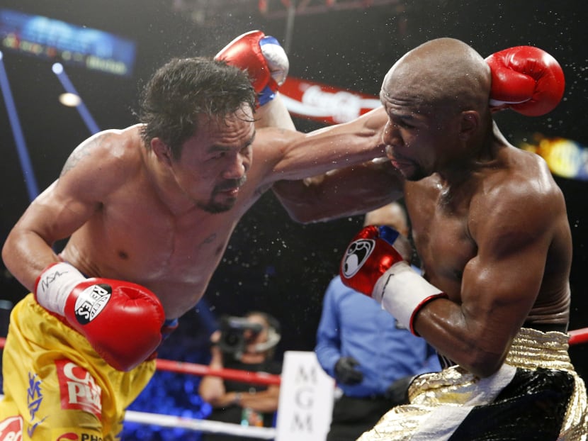 Manny Pacquiao, from the Philippines (left) trades blows with Floyd Mayweather Jr, during their welterweight title fight on Saturday, May 2, 2015 in Las Vegas. Photo: AP