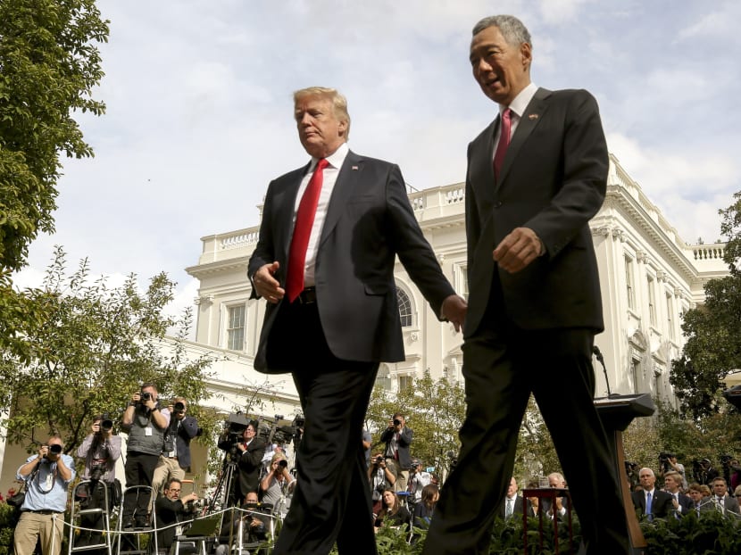 President Donald Trump, left, and Singapore's Prime Minister Lee Hsien, right depart together following a joint statement in the Rose Garden at the White House. Photo: AP
