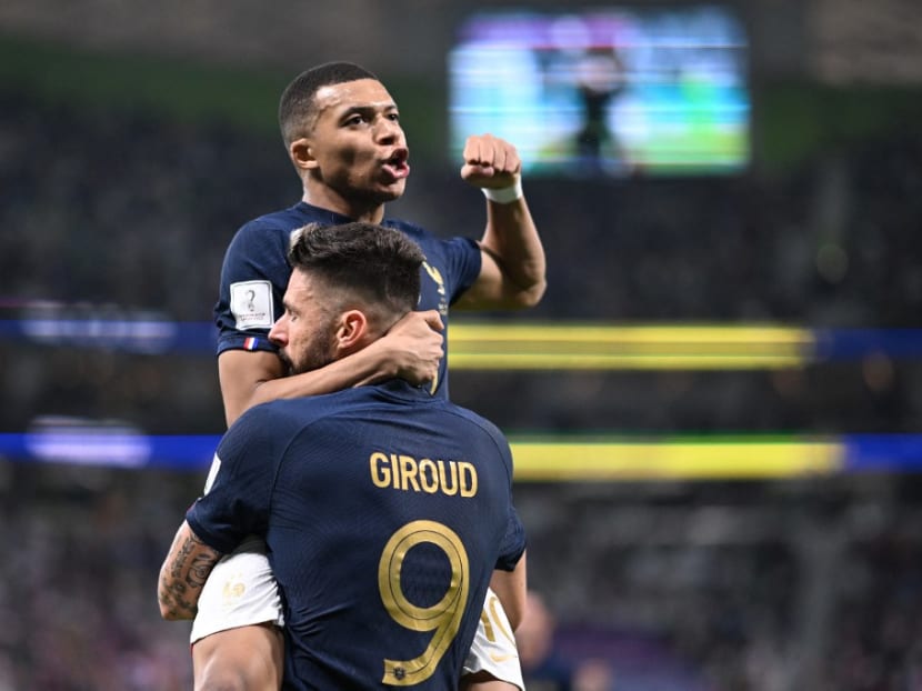 France's forward #9 Olivier Giroud celebrates with France's forward #10 Kylian Mbappe after scoring his team's first goal during the Qatar 2022 World Cup round of 16 football match between France and Poland at the Al-Thumama Stadium in Doha on Dec 4, 2022.
