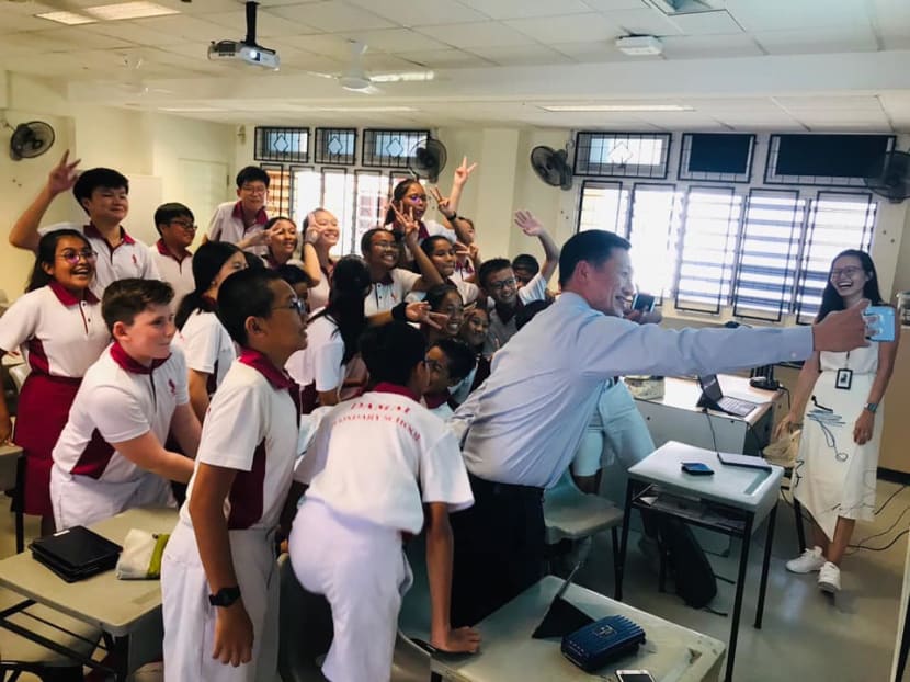 Education Minister Ong Ye Kung with students of Damai Secondary School during a visit to the school on Wednesday (March 27). The authors suggest setting up a Dreamfund for students from low-income families to use for enrichment classes and tuition, among others.