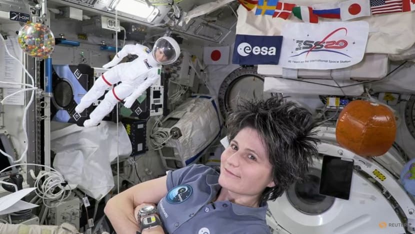 Space station's Italian commander, with lookalike Barbie, tells girls about science in orbit