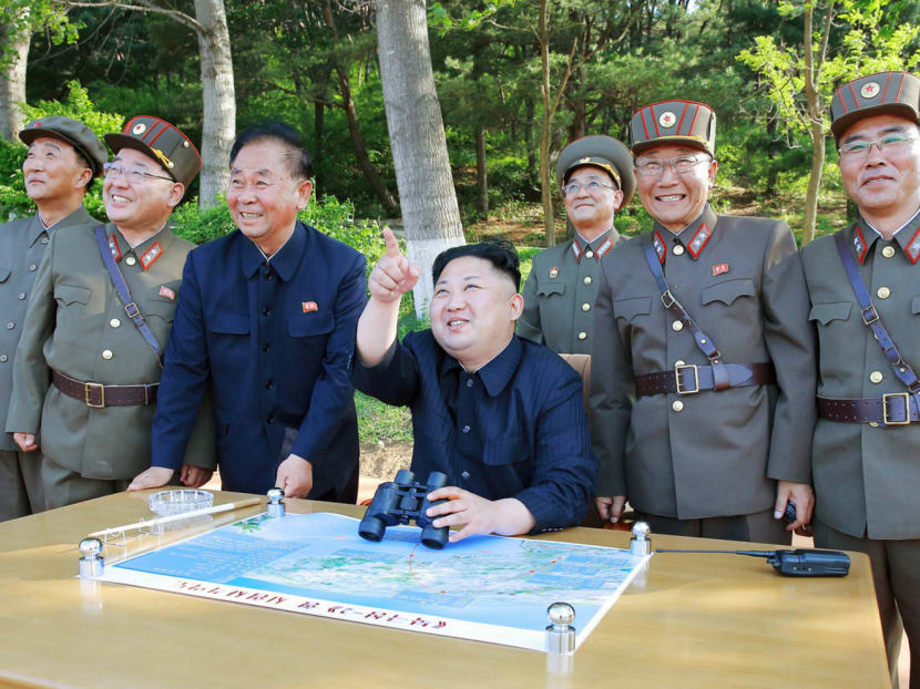 North Korean leader Kim Jong-un (centre) inspecting the launch test of the intermediate-range ballistic missile Pukguksong-2 with in an undated photo released by North Korea’s Korean Central News Agency on May 22 this year. PHOTO: REUTERS