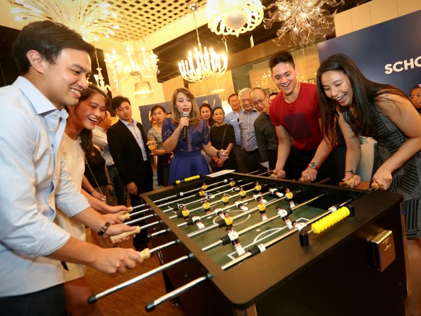 (From left) Teo Zhen Han, Richelle Ang, Joseph Schooling and Melisa Tay play a game of foosball to raise funds for the Schooling Sports Academy.// Joseph Schooling at Krislite Supports Schooling Sports Academy Fundraising event, where the lighting solutions provider will pledge to be the first corporate sponsor of the academy. Photo: Nuria Ling/TODAY