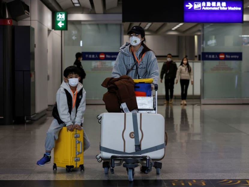 Travellers arrive at Hong Kong International Airport after the lifting of coronavirus disease (Covid-19) movement controls in Hong Kong, China Dec 14, 2022. 