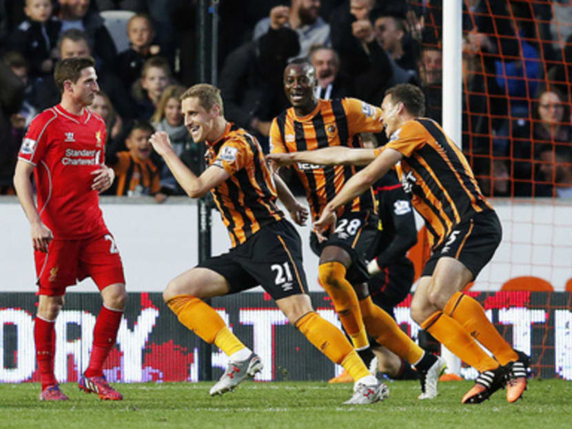 Michael Dawson (centre) celebrating with his team-mates after scoring the first goal for Hull, whose less-celebrated players gave everything in their win against Liverpool to avoid relegation. Photo: Reuters
