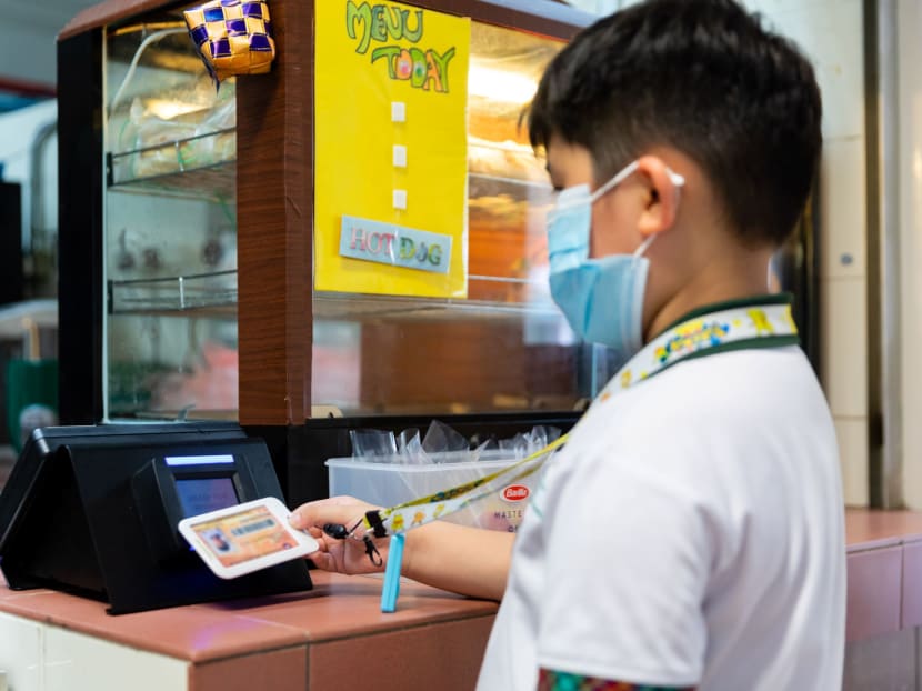 A student making a purchase at a POSB Smart Buddy tap-and-pay terminal at Xishan Primary School's canteen. 