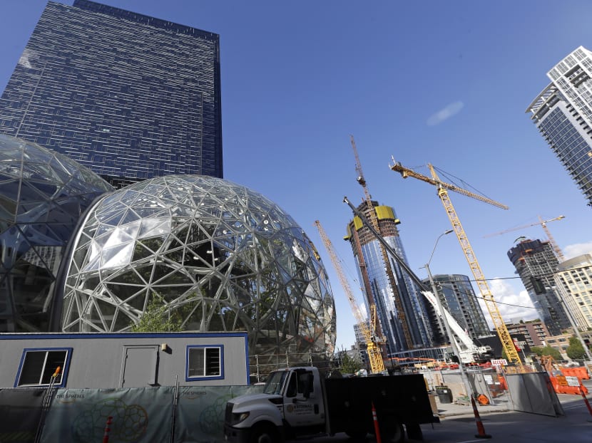 Large spheres take shape in front of an existing Amazon building, behind, as new construction continues across the street in Seattle. Photo: AP