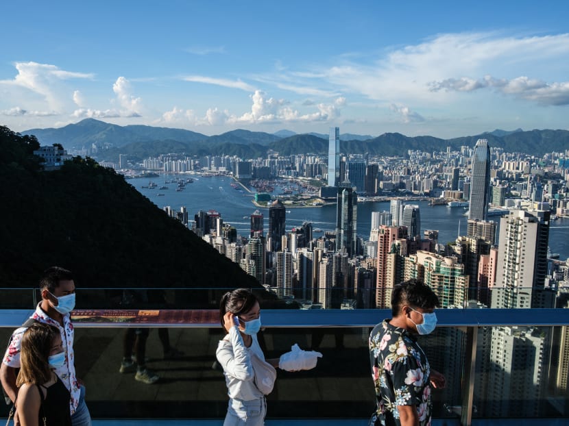 Visitors walk along a viewing platform on Victoria Peak in Hong Kong on July 28, 2020.