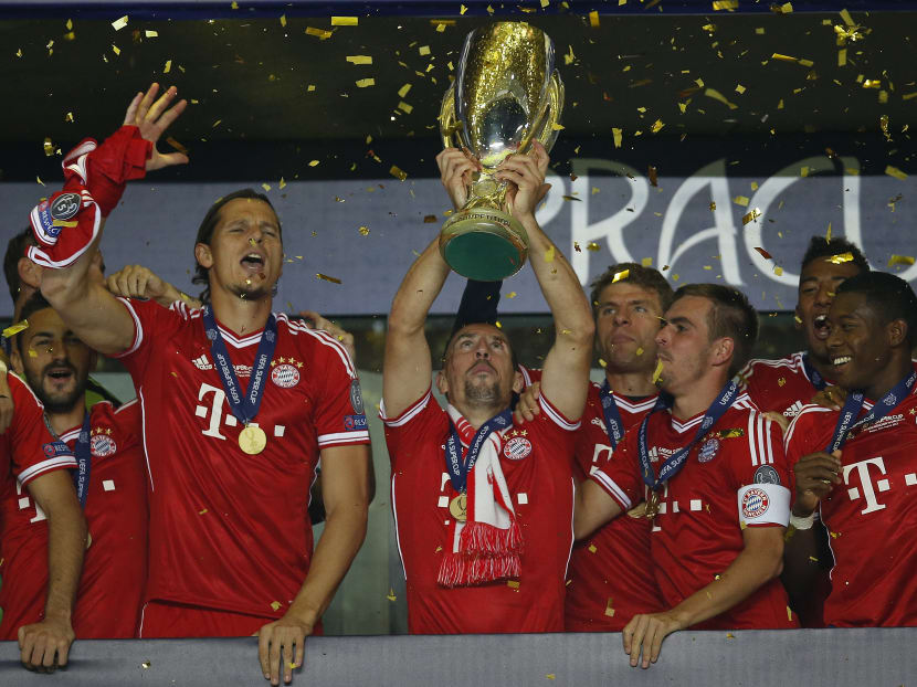 Bayern's Franck Ribery, centre, holds up the Super Cup after they defeated Chelsea in the soccer Super Cup final between Champions League winner Bayern Munich and Europa League winner Chelsea FC. Photo: AP