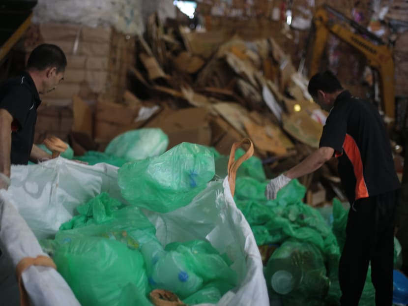 Workers sort plastic waste at a recycle plant. The top waste streams in Singapore in 2020 were: Paper and cardboard, ferrous metal, plastics, construction and demolition, and food.