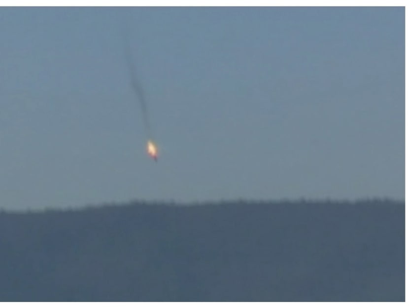 A war plane crashing in flames in a mountainous area in northern Syria after it was shot down by Turkish fighter jets near the Turkish-Syrian border, is seen in this still image taken from video November 24, 2015. Photo: Reuters