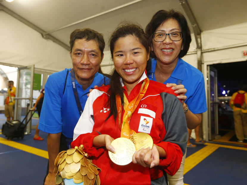 Yip Pin Xiu celebrates with her parents Yip Chee Khiong and Margaret Chong on Sept 16, 2016, after clinching her second gold medal at the Paralympics 2016. Photo: Sports Singapore via Reuters