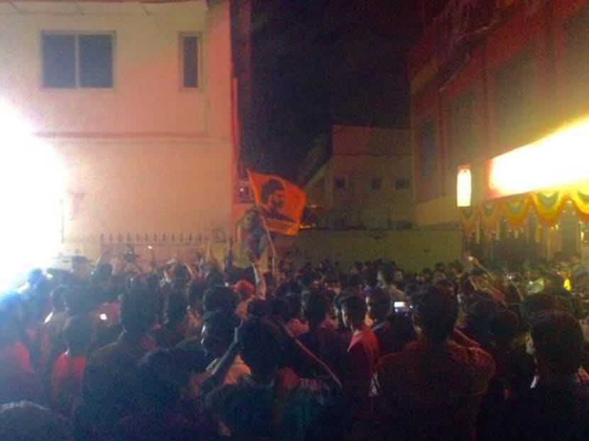 Flags and fireworks are seen outside a cinema showing the Baahubali movie. Photo: Twitter/@EAAbhishek