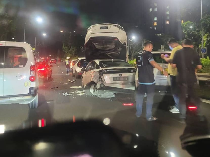 A car is seen lying on top of another after an accident involving six cars and a taxi along the Pan Island Expressway on May 31, 2022.