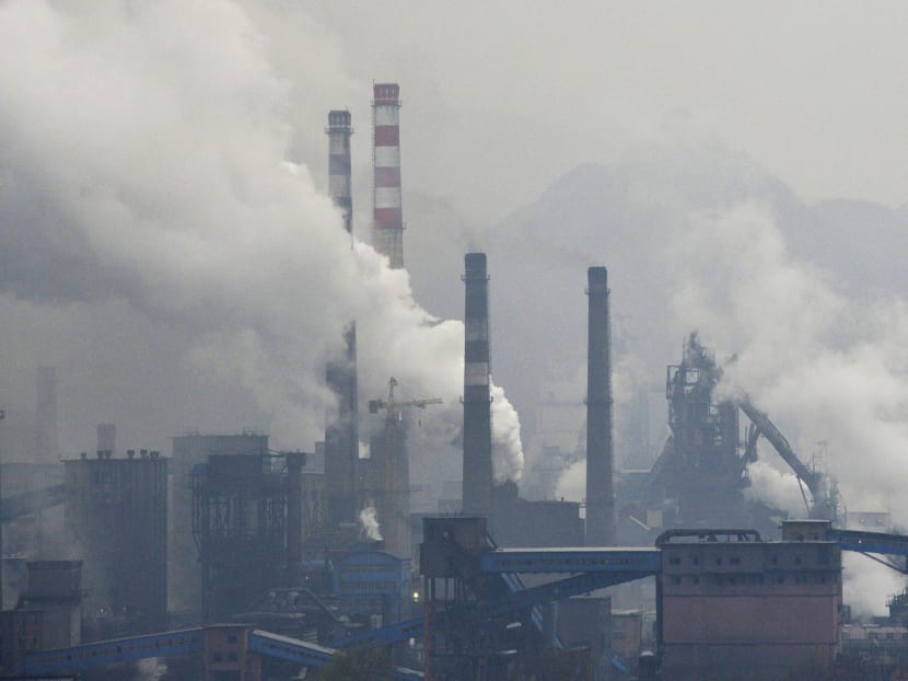 Smoke rising from steel plants on a hazy day in Benxi, Liaoning province, China. State-owned enterprises that burn coal, such as those from the steel sector, challenge official efforts to limit coal consumption. PHOTO: Reuters