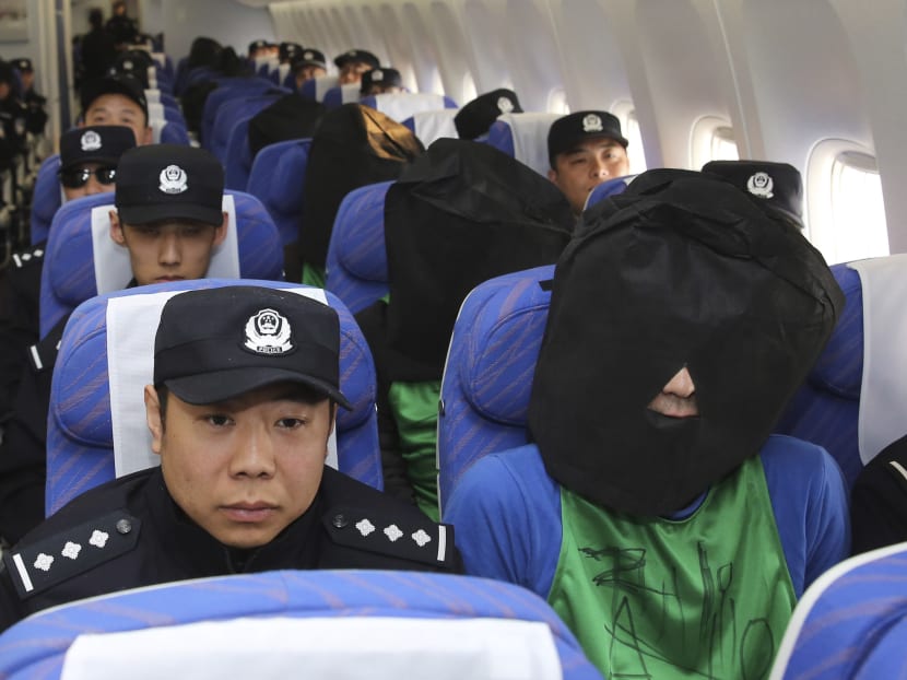In this April 13, 2016, Chinese and Taiwanese suspects involved in wire fraud sit in a plane as they arrive at the Beijing Capital International Airport in Beijing, China. Photo: Xinhua News Agency via AP