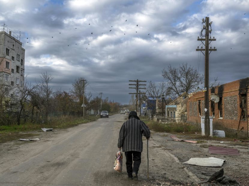 An old woman walks in the Kherson region village of Arkhanhelske on Nov 3, 2022, which was formerly occupied by Russian forces.