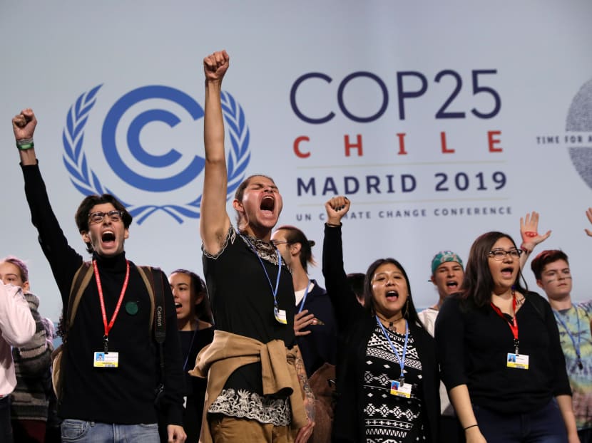 Young climate activists shout on stage at an event on climate emergency during the United Nations Climate Change Conference (COP25) in Madrid, Spain on Dec 11, 2019.