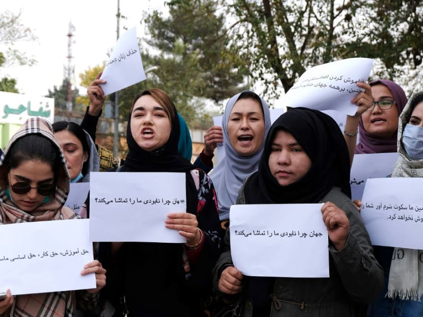 Women hold placards during a protest in Kabul on Oct 26, 2021, calling for the international community to speak out in support of Afghans living under Taliban rule. Women hold placards during a protest in Kabul on Oct 26, 2021, calling for the international community to speak out in support of Afghans living under Taliban rule.