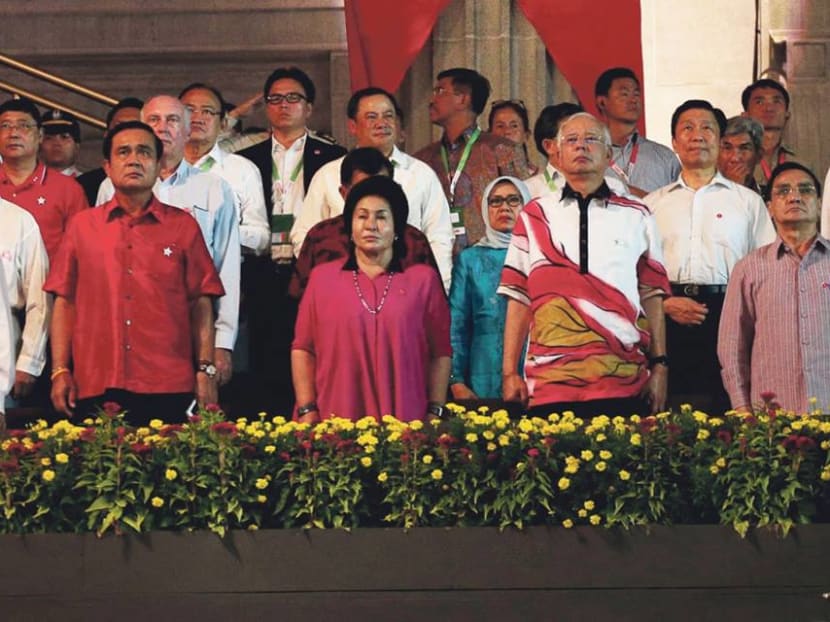 Malaysian Prime Minister Najib Razak (centre) and other foreign dignitaries stand during the national anthem at the National Day Parade on Aug 9 2015. Photo: Jason Quah