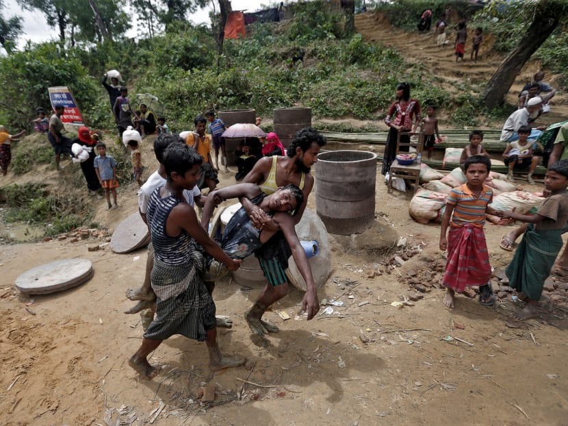 A Rohingya refugee being carried away after he collapsed while waiting to receive aid in Cox’s Bazar, Bangladesh, on Sunday. The influx into Cox’s Bazar has been described by the UN as the ‘most urgent refugee emergency in the world’. Photo: Reuters