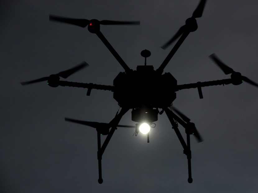 A police Unmanned Aerial Vehicle (UAV) with blinker and search light capabilities seen in flight. Photo: Jason Quah/TODAY