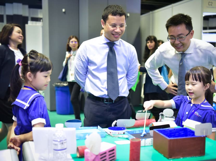 Minister for Social and Family Development Mr Desmond Lee visiting an exhibition booth at this year's Early Childhood Conference, where he had also announced a new leadership programme to develop the skills of principals and senior teachers. Photo: ECDA