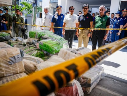 Philippine President Ferdinand Marcos (centre, in white shirt) and Interior Secretary Benhur Abalos (second from right) inspect seized methamphetamine drugs in Alitagtag town in Batangas province on April 16, 2024.
